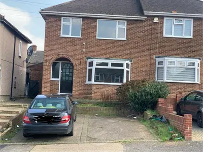 a car parked in front of a brick house at Contractor & Family Friendly House Romford in Havering atte Bower