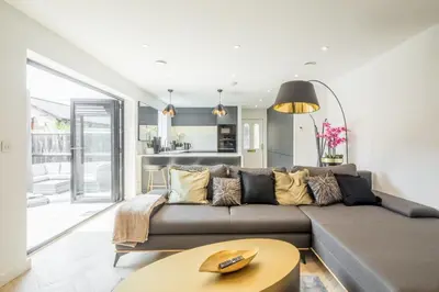 a living room with a couch and a table at Luxury 2 Bedroom Apartment with AC and Parking in Cambridge