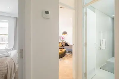 a bathroom with a glass door leading to a bedroom at Luxury 2 Bedroom Apartment with AC and Parking in Cambridge