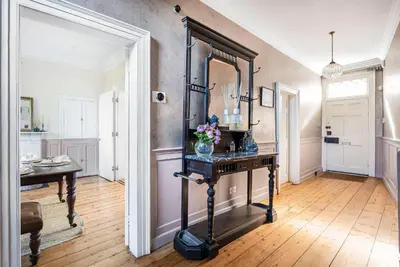 a room with a table and a mirror on a wall at London- Large Period Town House with river front in Hertford
