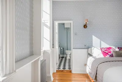 a bedroom with a bed and a bathroom with a toilet at London- Large Period Town House with river front in Hertford