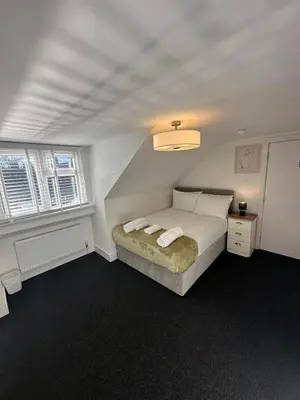 a bedroom with a bed and two windows at Cambridge Central Rooms - Tas Accommodations in Cambridge