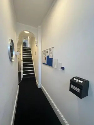 a hallway with a stairway with a stair case at Cambridge Central Rooms - Tas Accommodations in Cambridge