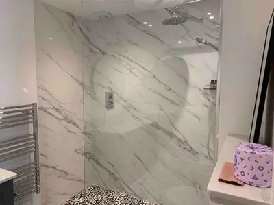a bathroom with a shower with white marble at Private 2 Bedroom Apartment at Woodland Retreat in Gamlingay