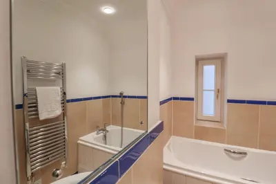 a bathroom with a tub and a shower and a sink at 9 Church Farm Rise in Aldeburgh