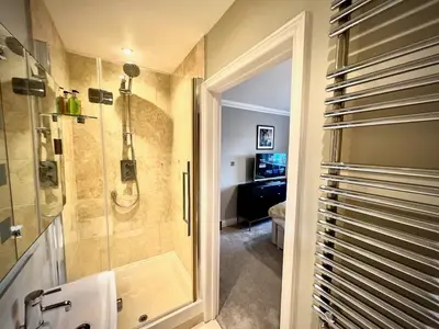 a bathroom with a shower and a walk in shower at Honey Hill Cottage - 4 Bedroom Detached House in Cambridge