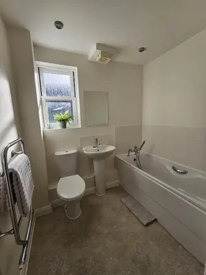 a bathroom with a toilet and a sink and a bath tub at Eaglegate in Colchester