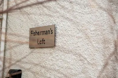 a sign on a building that reads freshmen left at Fishermans Loft - A seaside house in Thorpeness with direct access to the beach - Aldeburgh Coastal Cottages in Thorpeness