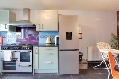 a kitchen with a refrigerator and a stove at Blackwater Terrace Witham in Faulkbourne