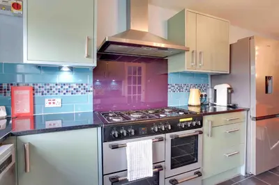 a kitchen with a stove top oven in a kitchen at Blackwater Terrace Witham in Faulkbourne