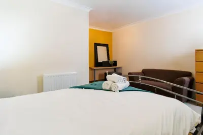 a bedroom with a bed with two towels on it at Cambridge 4 Bedroom Sleeps 9 Wi-Fi Garden, LONG STAYS ACCEPTED- Orchid House in Cambridge