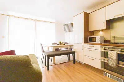 a small kitchen with a table and a microwave at Cambridge 4 Bedroom Sleeps 9 Wi-Fi Garden, LONG STAYS ACCEPTED- Orchid House in Cambridge