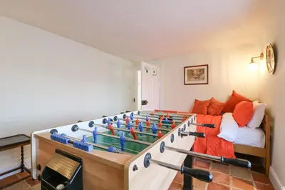 a room with a foosball game on a bed at West House Farm in Leiston