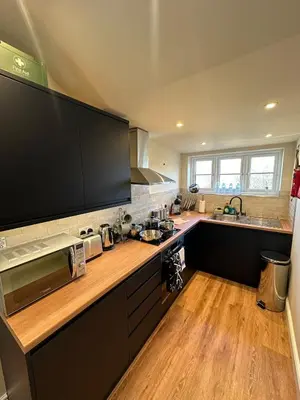 a kitchen with a large flat screen tv on the counter at Central Cambridge Apartments by Tas in Cambridge