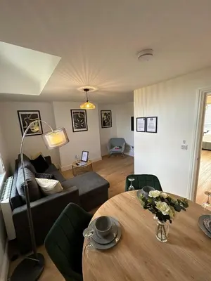 a living room with a couch and a table at Central Cambridge Apartments by Tas in Cambridge