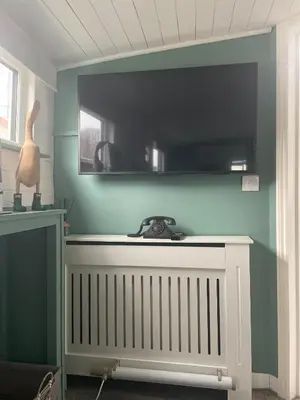 a room with a white radiator and a blue wall at Judith Barge in Colchester
