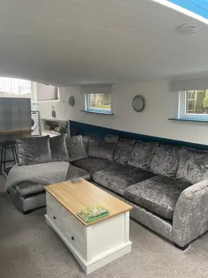 a living room with a couch and a coffee table at Judith Barge in Colchester