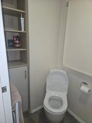 a small bathroom with a toilet and a roll of toilet paper at Jenny,s place in Saint Osyth