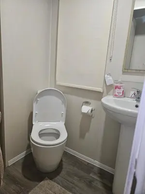 a bathroom with a toilet and a sink at Jenny,s place in Saint Osyth