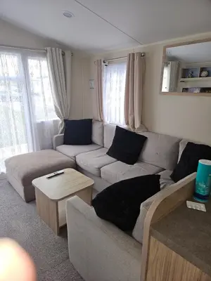 a living room with a couch and a table at Jenny,s place in Saint Osyth