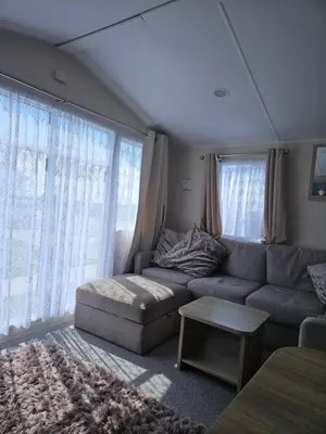 a living room with a couch and a table at Jenny,s place in Saint Osyth