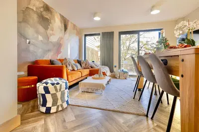 a living room with a couch and a table at Luxury Stay, City Walk, Pool Table & Air Hockey, Garden, Parking, Business & Families - Oakview in Colchester