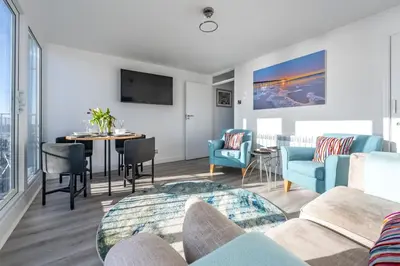 a living room with a couch and a table at 19 Undercliffe in Felixstowe