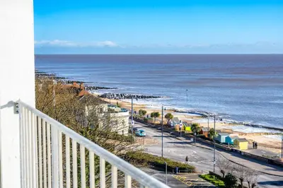 a balcony with a view of the beach and the ocean at 19 Undercliffe in Felixstowe