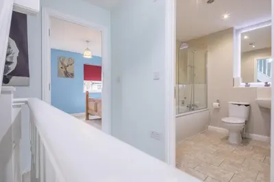 a bathroom with a toilet and a walk in shower at Modern and Comfy 3 bed Cambridge House in Cambridge