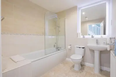 a bathroom with a toilet and a sink and a shower at Modern and Comfy 3 bed Cambridge House in Cambridge