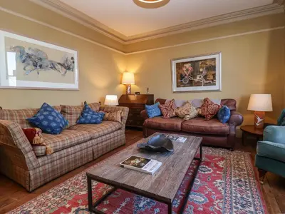 a living room with couches and a table at 11a Market Cross Place in Aldeburgh