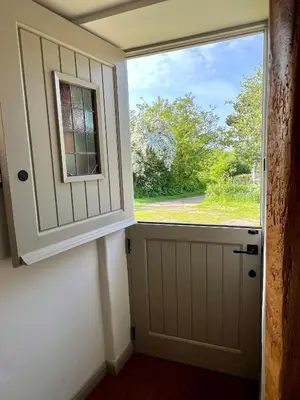 a door with a window in a room at The Old Stable at Manor House, Middleton in Middleton
