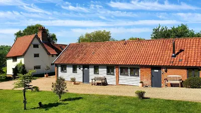 a large white house with a red roof at The Nook in Halesworth