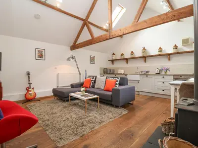 a living room with a couch and a table at The Nook in Halesworth