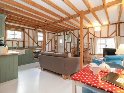 a kitchen and living room with a couch and a table at Twosome in Halesworth
