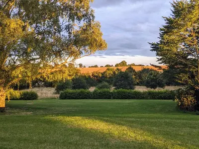 a large green field with trees and bushes at Twosome in Halesworth