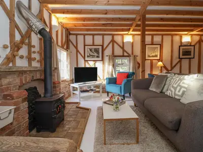 a living room with a couch and a fireplace at Twosome in Halesworth
