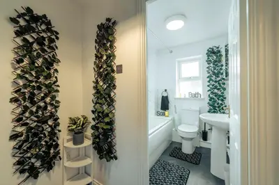 a bathroom with a white toilet and a sink at 2 Bedroom Peaceful Home, Colchester in Mile End