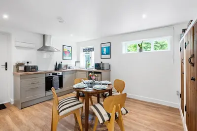 a kitchen and dining room with a table and chairs at Barn studio in Long Melford in Long Melford