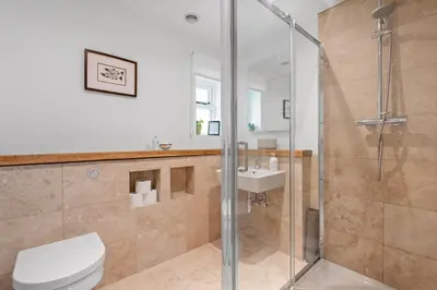 a bathroom with a shower and a toilet and a sink at Barn studio in Long Melford in Long Melford