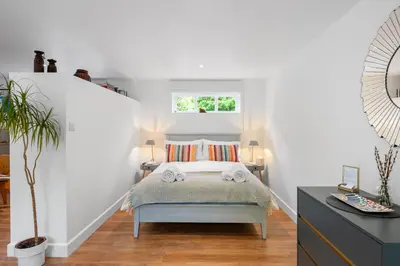 a small bedroom with a bed and a window at Barn studio in Long Melford in Long Melford