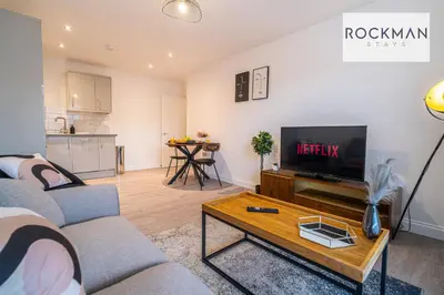 a living room with two couches and a tv at Royal Oak Apartments 3 - Secure Parking - Perfect for Contractors - 2 Bedroom - 2 Bathroom - Fast Wi-fi - Long Term Stays - in Brentwood