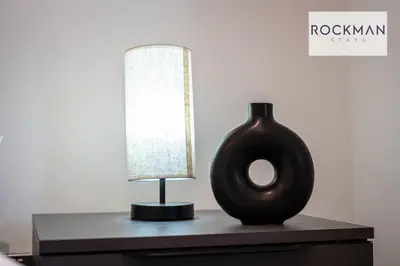 a lamp and a vase on a table at Royal Oak Apartments 3 - Secure Parking - Perfect for Contractors - 2 Bedroom - 2 Bathroom - Fast Wi-fi - Long Term Stays - in Brentwood