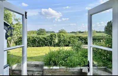 an open window with a view of a field at Chelmsford Cottage Free Parking Fab Garden in Great Waltham