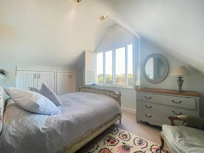 a bedroom with a bed with a mirror and a dresser at Spinneys Beachfront home, Indoor Pool UK-Vacations in Thorpeness