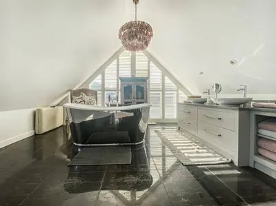 a bathroom with a bath tub and a sink at Spinneys Beachfront home, Indoor Pool UK-Vacations in Thorpeness