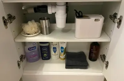 a cupboard with a sink and toiletries at Beautiful Peaceful Studio Flat in Waltham Abbey