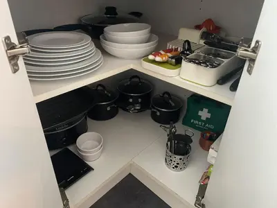 a kitchen with plates and dishes on a shelf at Beautiful Peaceful Studio Flat in Waltham Abbey