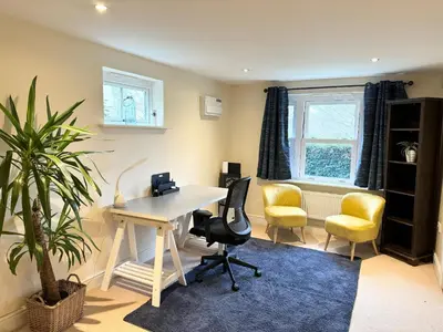 an office with a desk and chairs and a plant at Riverview Colchester in Colchester