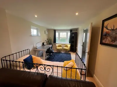 a bedroom with a bed and a living room at Riverview Colchester in Colchester
